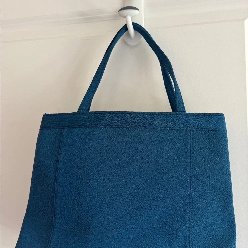 Teal-colored‎ handbag bag featuring intricate floral embroidery